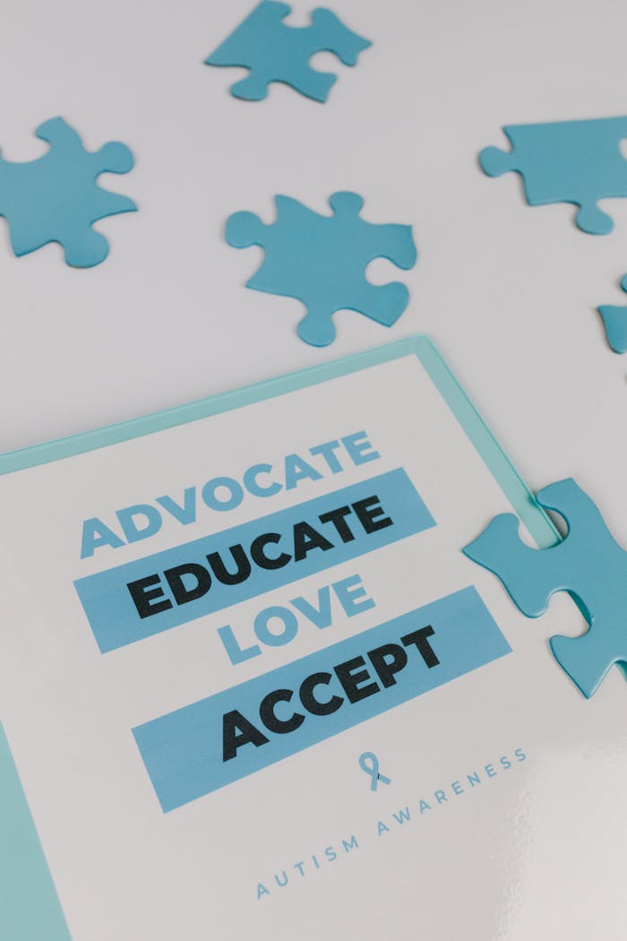 Close-up of autism awareness poster surrounded by blue puzzle pieces.